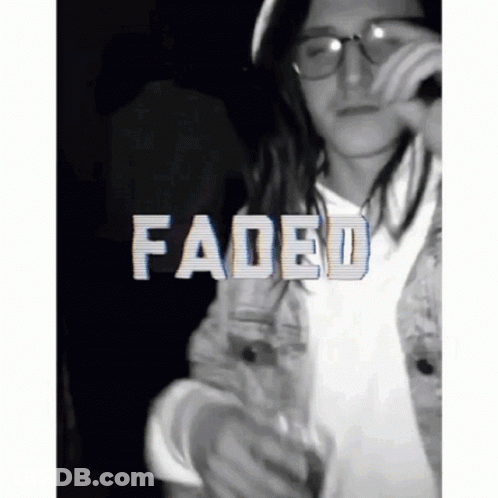 A Man With Long Hair And Glasses Is Holding A Microphone And The Word Faded Is On The Bottom GIF