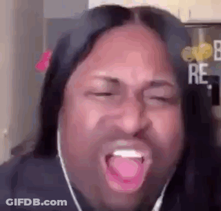 A Man With Long Hair And Headphones Is Making A Funny Face With His Mouth Open . GIF
