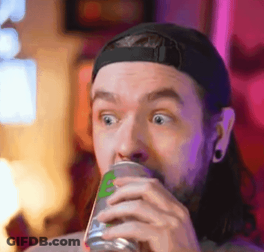 A Man With Long Hair Is Drinking From A Can . GIF