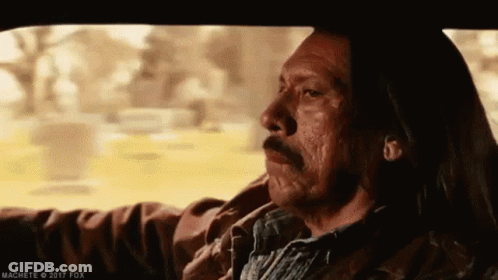 A Man With Long Hair Is Driving A Car With His Eyes Closed . GIF