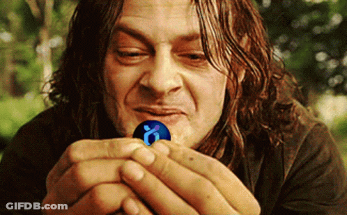 A Man With Long Hair Is Holding A Blue Ball With A Letter O On It GIF