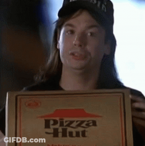 A Man With Long Hair Is Holding A Box Of Pizza Hut Pizza GIF