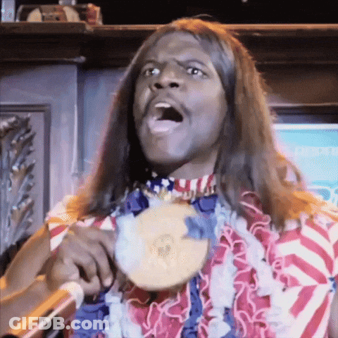 A Man With Long Hair Is Holding A Medal Around His Neck GIF
