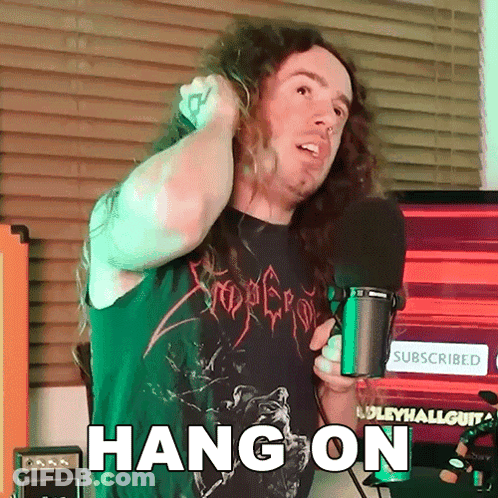Man With Long Hair Holding Microphone GIF