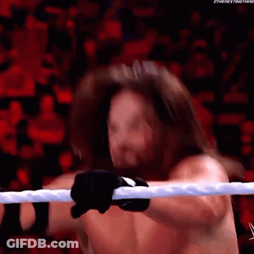 A Man With Long Hair Is Holding A Rope In A Wrestling Ring .. GIF
