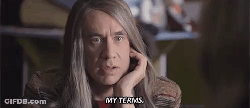 A Man With Long Hair Is Making A Funny Face And Says `` My Terms '' . GIF