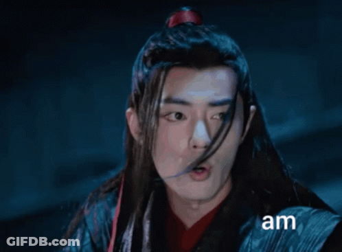 A Man With Long Hair Is Making A Funny Face And The Word Am Is On The Bottom GIF