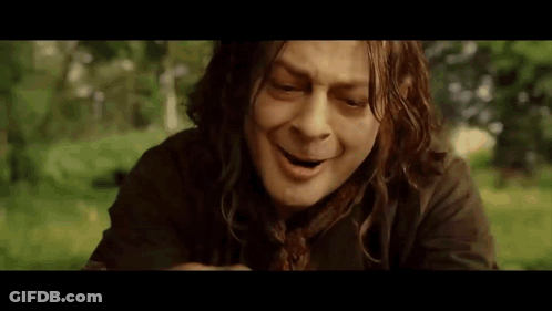 A Man With Long Hair Is Making A Funny Face While Sitting In The Grass . GIF