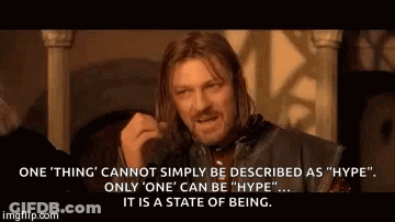 A Man With Long Hair Is Making A Funny Face While Talking About A State Of Being . GIF