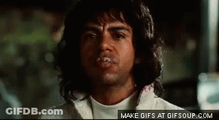 A Man With Long Hair Is Making A Funny Face With His Mouth Covered In Saliva . GIF