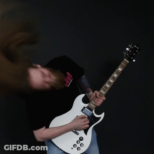 A Man With Long Hair Is Playing A White Guitar GIF
