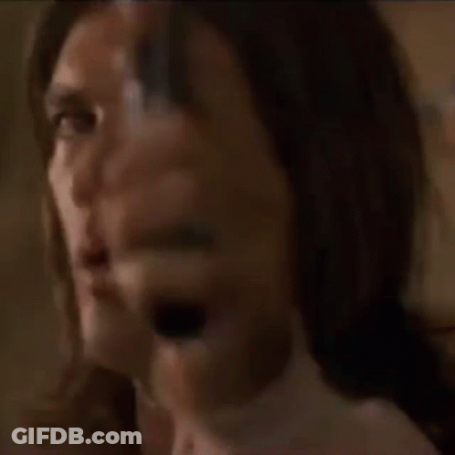 A Man With Long Hair Is Pointing A Gun At Someone GIF