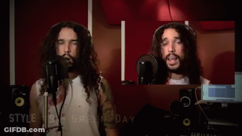 A Man With Long Hair Is Singing Into A Microphone With The Words Style # 10 Gregorian Chante Below Him GIF