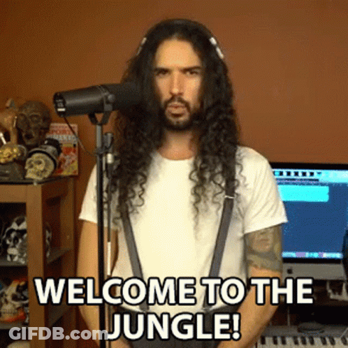 A Man With Long Hair Is Singing Into A Microphone With The Words Welcome To The Jungle Below Him GIF