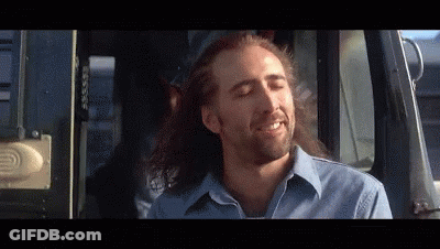 A Man With Long Hair Is Sitting In A Car With His Eyes Closed GIF