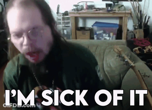 A Man With Long Hair Is Sitting On A Couch With The Words I 'M Sick Of It Behind Him GIF
