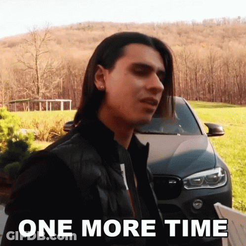 A Man With Long Hair Is Standing In Front Of A Car With The Words One More Time Below Him GIF