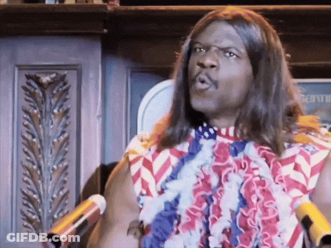 A Man With Long Hair Is Standing In Front Of A Microphone Wearing An American Flag Shirt GIF