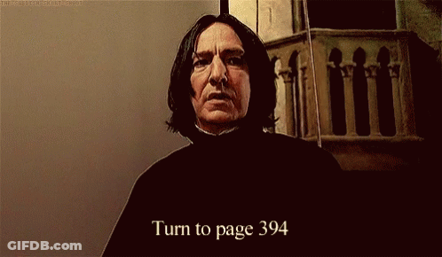 A Man With Long Hair Is Standing In Front Of A Wall And Says Turn To Page 394 GIF
