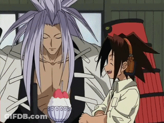 A Man With Long Hair Is Standing Next To Another Man GIF