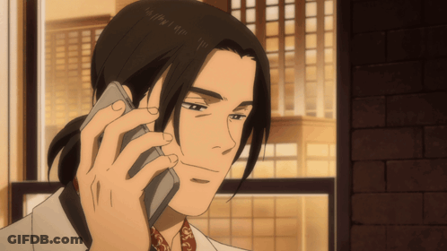 A Man With Long Hair Is Talking On A Phone GIF
