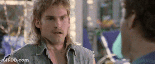 A Man With Long Hair Is Talking To Another Man . GIF