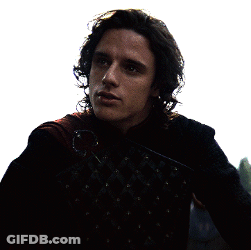 A Man With Long Hair Is Wearing A Black Jacket With Studs GIF