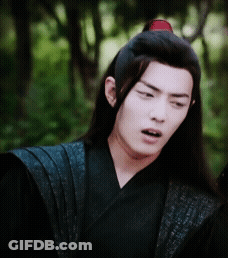 A Man With Long Hair Is Wearing A Black Kimono And A Red Headband GIF