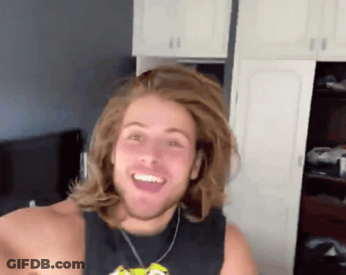 Smiling Man With Long Hair In Black Tank Top GIF