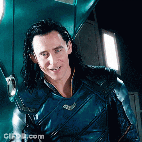A Man With Long Hair Is Wearing A Blue Armored Jacket And Smiling . GIF