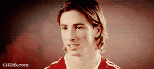 A Man With Long Hair Is Wearing A Red And White Shirt GIF