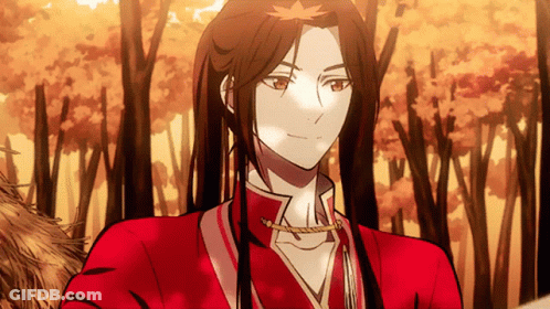 A Man With Long Hair Is Wearing A Red Shirt GIF
