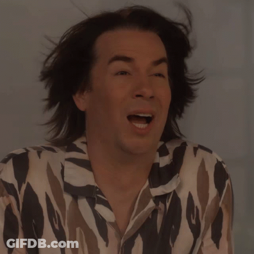 A Man With Long Hair Is Wearing A Shirt That Says ' Zebra ' On It GIF