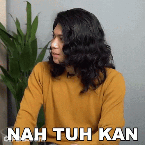 A Man With Long Hair Is Wearing A Yellow Shirt And Says Nah Tuh Kan GIF