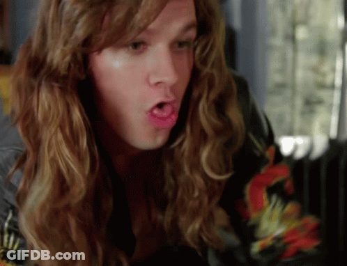 A Man With Long Hair Making A Funny Face With His Mouth Open GIF