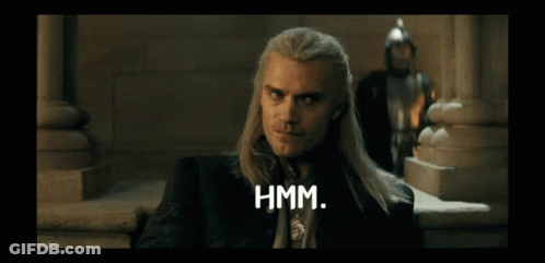 A Man With Long Hair Says Hmm In Front Of A Man In A Knight 'S Helmet GIF