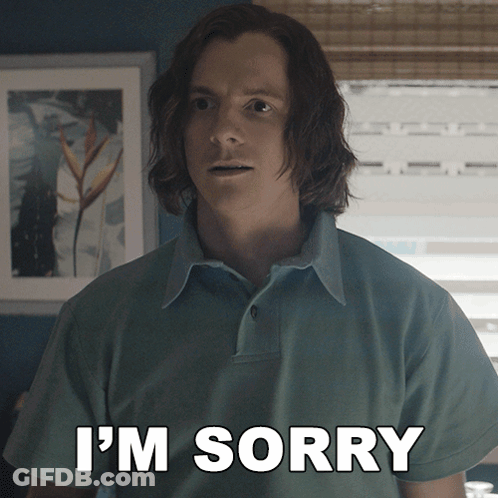 A Man With Long Hair Says I 'M Sorry In Front Of A Window GIF