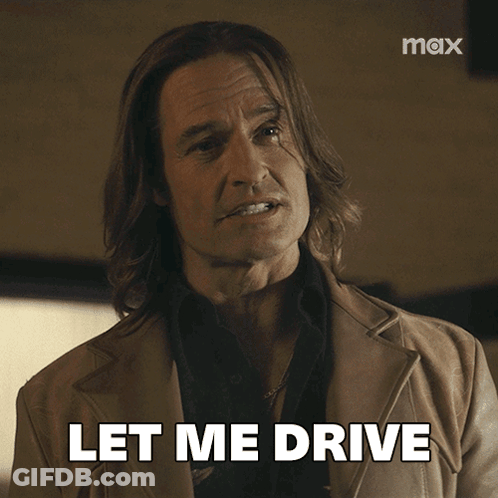 A Man With Long Hair Says Let Me Drive In Front Of A Max Logo GIF