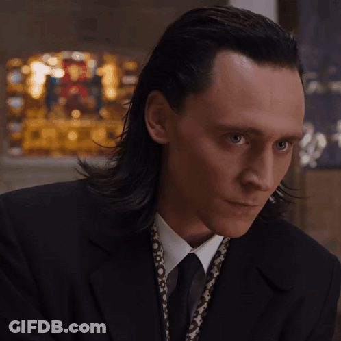 Man With Long Hair In Black Suit And Tie GIF