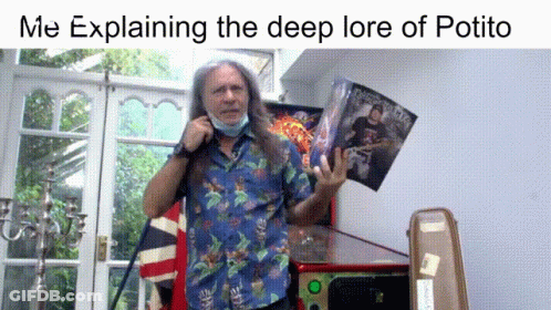A Man With Long Hair Wearing A Face Mask Is Explaining The Deep Lore Of Potito In A Living Room GIF