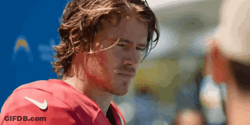 A Man With Long Hair Wearing A Red Nike Jersey GIF