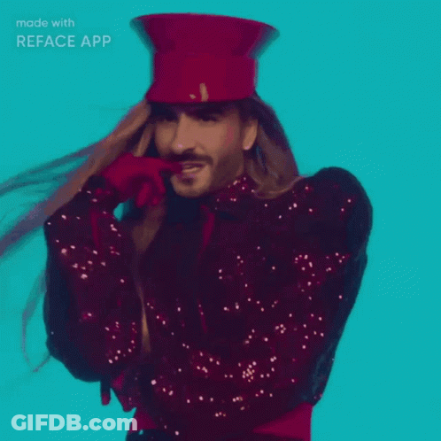 A Man With Long Hair Wearing A Red Top Hat And Sequined Jacket Made With Reface App GIF