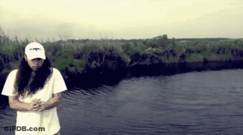 A Man With Long Hair Wearing A White Hat That Says Ak47 GIF