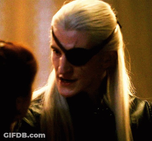 A Man With Long White Hair And A Black Eye Patch On His Forehead GIF