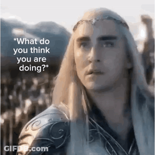 A Man With Long White Hair And A Crown On His Head Is Standing In Front Of A Mountain . GIF