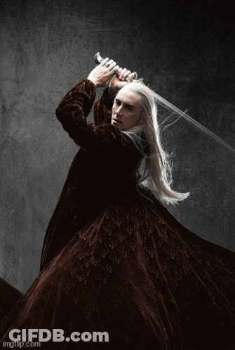 A Man With Long White Hair Is Holding A Large Sword In His Hand . GIF