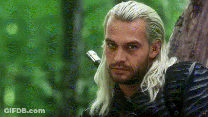 A Man With Long White Hair Is Leaning Against A Tree And Holding A Sword . GIF