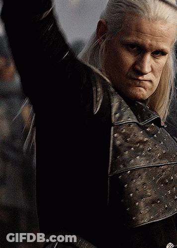 A Man With Long White Hair Is Wearing A Black Leather Jacket GIF