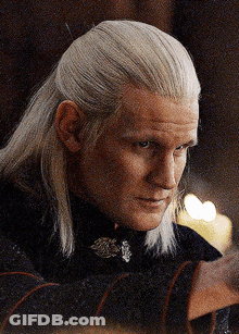 A Man With Long White Hair Is Wearing A Black Top GIF