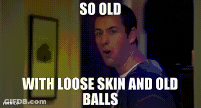 A Man With Loose Skin And Old Balls Is Standing In A Hallway GIF